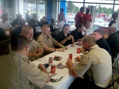 Team of Glen Sain GMC, Kennett enjoying snacks and drinking Coca-Cola