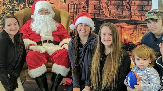 Family posing with Santa Claus
